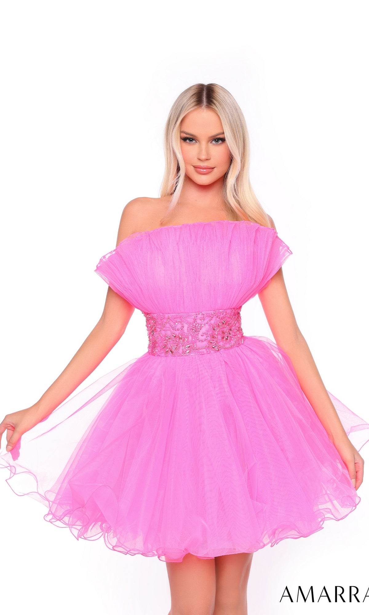 A woman poses against a white background wearing the Short Homecoming Dress 88038 by Amarra, a bright pink pleated A-line dress featuring a beaded waist.